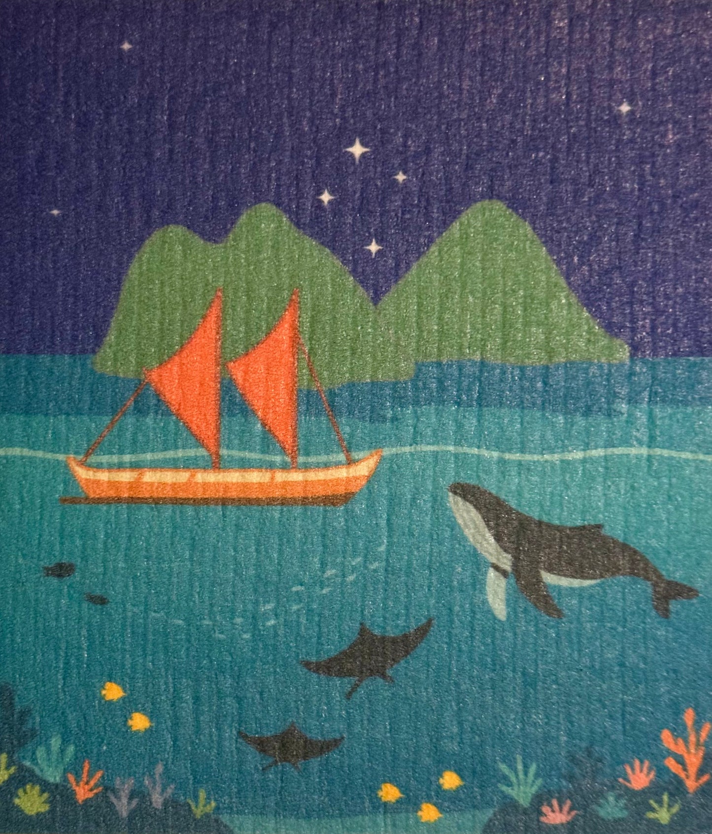 Illustration of a voyaging canoe with red sails and a whale in a night-time ocean scene.